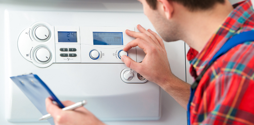 Technician servicing the gas boiler for hot water and heating